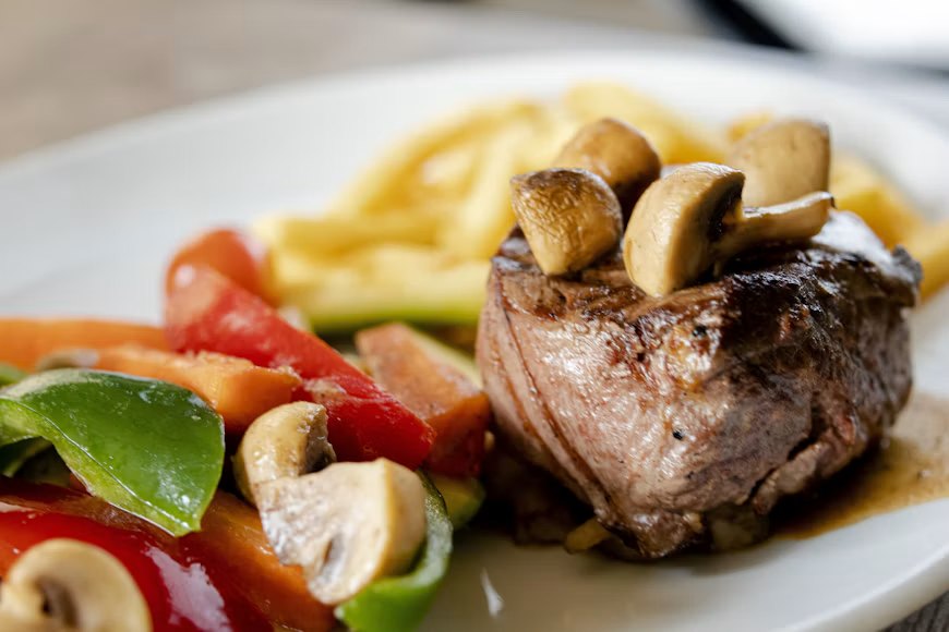 Mushroom steak with seasonal vegetables, catered for a dinner party at home in Lahore